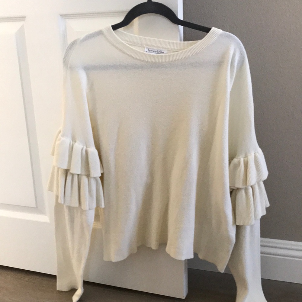 ruffled white sweater
